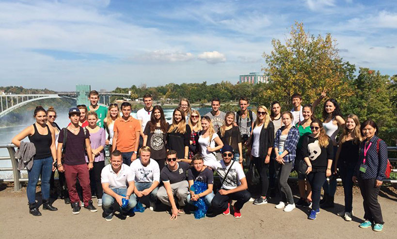 Our Tour Group Photo at Niagara Falls Our Tour Group at Niagara Falls with the Rainbow Bridge in the background.