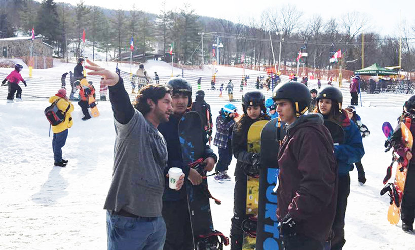 Our Escort giving students directions at Mountain Creek Our Escort Instructing Snowboarders On One of Our Mountain Creek Ski/Snowboard Tours.